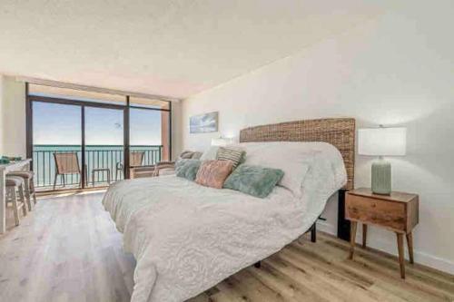a bedroom with a bed with a view of the ocean at Soul Sanctuary-Direct oceanfront-Million dollars view-King bed-Free Parking-Self check-in in Myrtle Beach
