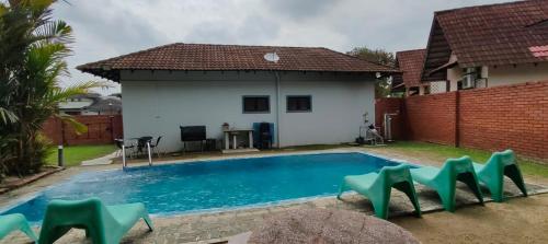 a swimming pool in front of a house at Beatiful Afamosa Golf Resort Private villa with pool 3 rooms lot 1280 bumiputra only in Kampong Alor Gajah