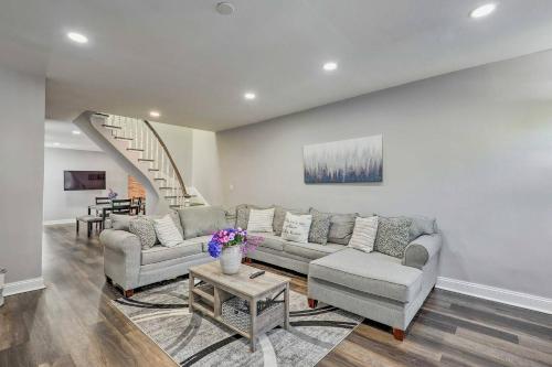 a living room with a couch and a table at Baltimore Abode, Walk to Cross Street Market! in Baltimore
