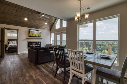 a dining room and living room with a table and chairs at Broadview, River, Golf Course, Games, free Attraction Tickets, WIFI!!! in Kodak