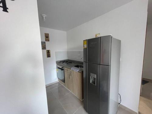 a kitchen with a stainless steel refrigerator and a stove at Para estrenar agradable apartamento acogedor in Cúcuta