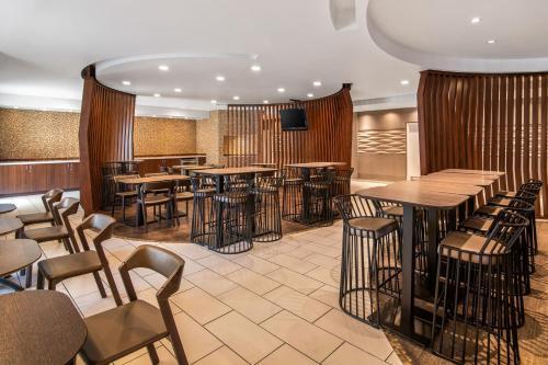 a restaurant with tables and chairs and a television at SpringHill Suites Las Vegas Henderson in Las Vegas