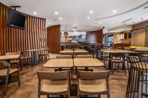 a restaurant with tables and chairs and a bar at SpringHill Suites Las Vegas Henderson in Las Vegas