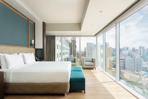a hotel room with a bed and a large window at Courtyard by Marriott Lima Miraflores in Lima