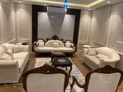 a living room with two couches and a table at شاليه العماريه in Yanbu Al Bahr