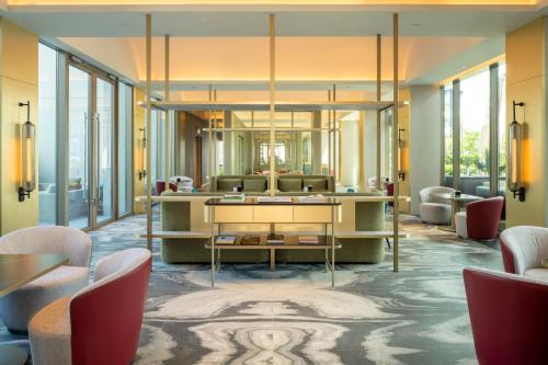 a lobby with a reception desk and chairs at Pan Pacific Orchard in Singapore