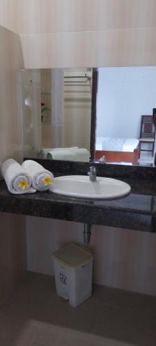 a bathroom counter with a sink and a mirror at Kelana Guest House manage by LBV in Jimbaran