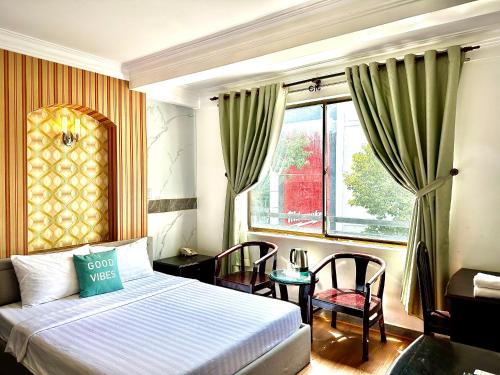 a hotel room with a bed and a window at Anh Duy Hotel - Nguyễn Công Trứ The Bitexco Neighbour in Ho Chi Minh City