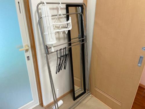 a refrigerator in a room next to a door at 憩いの場　ただいま〜 in Nago