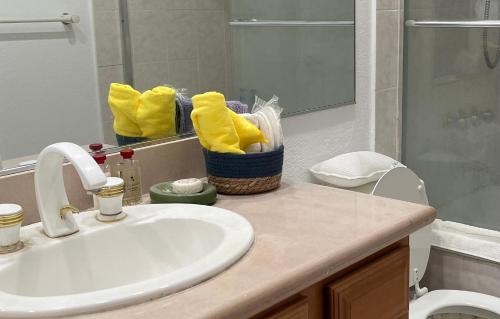 a bathroom with a sink and a toilet and a mirror at Ploy in Monterey Park