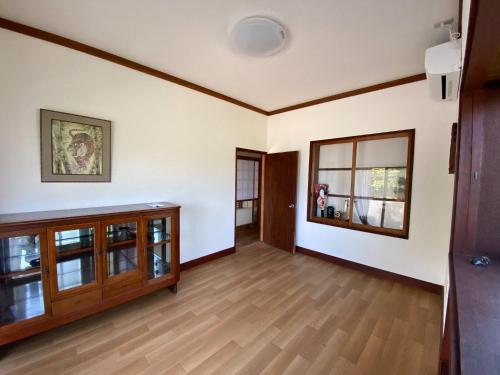 a living room with white walls and wooden floors at Wakamizu Minpaku in Tōganemachi