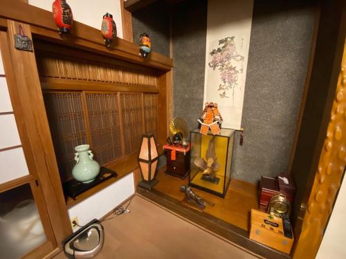 a shelf with various items on it in a room at Wakamizu Minpaku in Tōganemachi