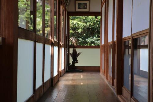 a hallway of a house with large windows at Wakamizu Minpaku in Tōganemachi