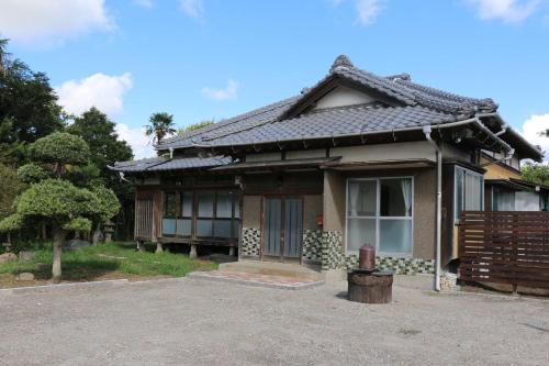 a japanese house with a gate in front of it at Wakamizu Minpaku in Tōganemachi