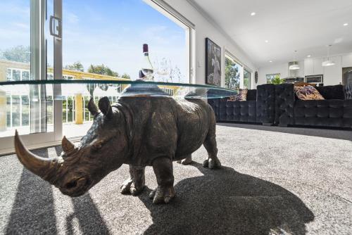a statue of a rhino with a bowl on its head at The Whitehouse - Lepperton Holiday Home in New Plymouth
