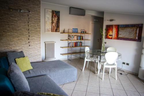 a living room with a couch and a table and chairs at APPARTAMENTO CAMPOVOLO in Reggio Emilia