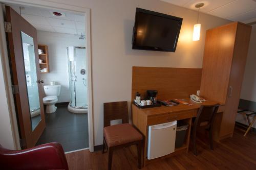 um quarto com casa de banho com lavatório e WC em Hotel du Fjord em Saguenay
