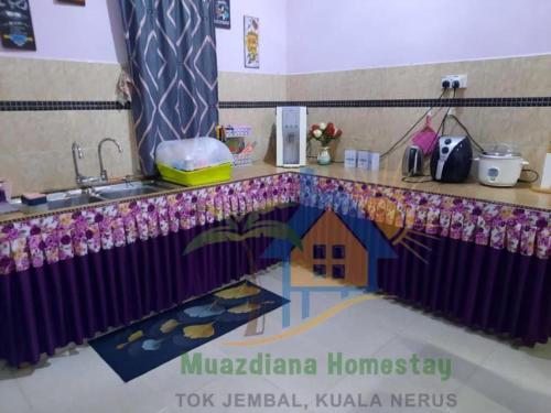 a kitchen counter with a sink and a house on it at MUAZDIANA HOMESTAY di KUALA NERUS, GONG BADAK in Kampong Tanjong Gelam