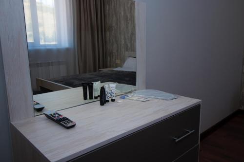 a desk in a hotel room with a mirror at Happy home in Tsaghkadzor