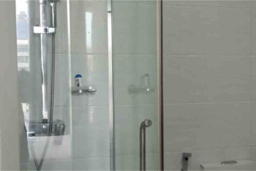 a shower with a glass door in a bathroom at Spectacular Sea View 3 Bedrooms Apartment in Colombo