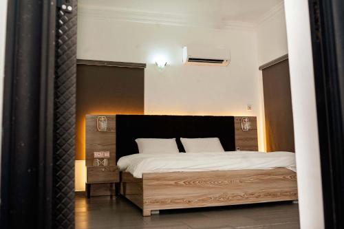 a bedroom with a large bed with white sheets at Ebrina One Bedroom in Port Harcourt