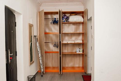 a closet with wooden shelves in a room at Ebrina One Bedroom in Port Harcourt
