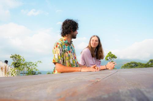 a man and a woman sitting on top of a table at leisure Mount View in Haputale