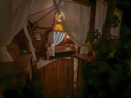 Remy's Nest في تاجيتاي: غرفه فيها خيمه فيها سرير