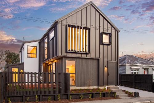 a house with a black and white facade at Chatham Street - Christchurch Holiday Homes in Christchurch