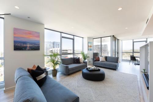 a living room with a couch and a table at Metropolitan 70 in Canberra