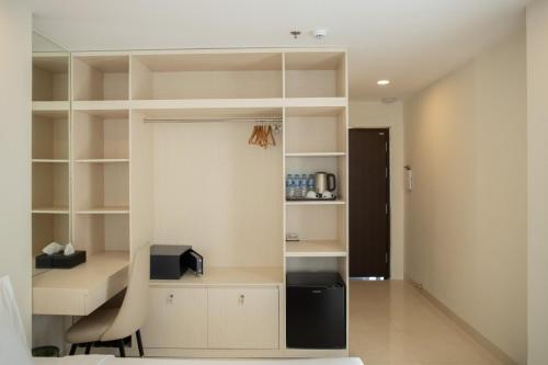 a room with white shelves and a desk and a chair at Ruby Hotel in Ho Chi Minh City