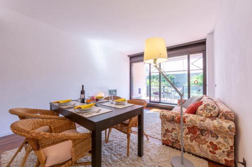 a living room with a table and a couch at Lugano Centro- Happy Rentals in Lugano