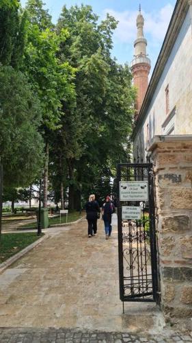 a group of people walking down a street next to a building at Cozy 2 bedroom near Green Mosque in Yıldırım