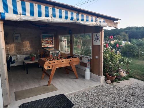 a game room with a foosball table on a patio at Le Logis du Bouil in Champagne