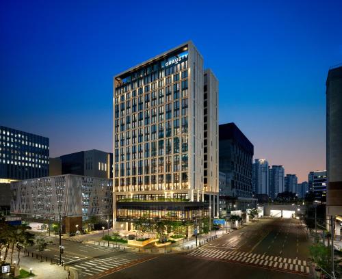 a tall building in a city at night at GRAVITY Seoul Pangyo, Autograph Collection in Seongnam