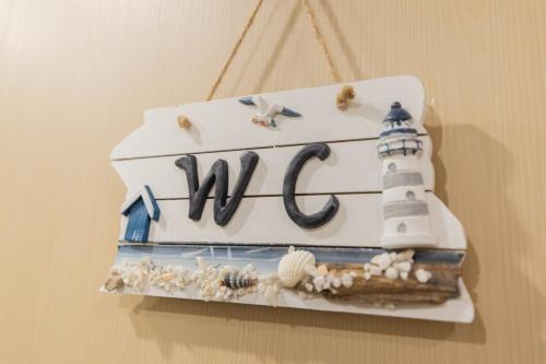 a cake with a lighthouse on it hanging on a wall at Căn hộ Studio The Sóng Vũng Tàu in Vung Tau