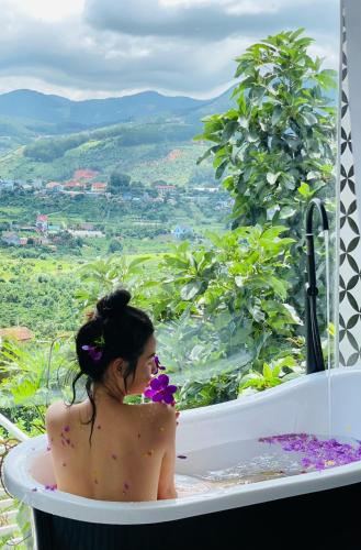 a woman sitting in a bath tub with a view at Nacasoo hill in Tiên Hai