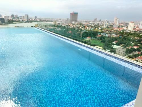 a swimming pool with a view of the city at Grand Condo 7 in Phnom Penh