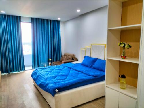 a bedroom with a blue bed with blue sheets at Grand Condo 7 in Phnom Penh