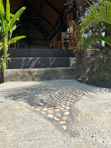 a pile of rocks on the ground next to some stairs at Island Garden Huts Lembongan in Nusa Lembongan