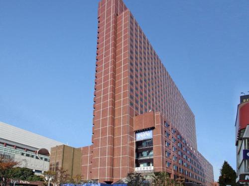 a tall red brick building in a city at Shinjuku Prince Hotel in Tokyo