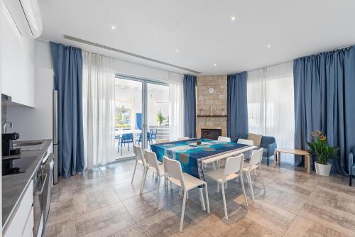 a kitchen and dining room with a table and chairs at Blue Diamond Beach Villas in Paphos City