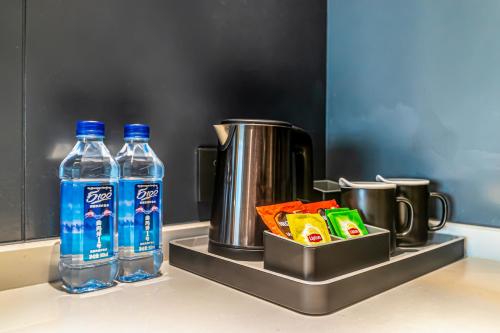 a counter with two bottles of water and a container of food at Empathy Hotel - Guangzhou East Railway Station Tianhe Sports Center in Guangzhou