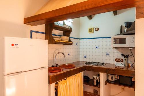 a kitchen with a white refrigerator and a sink at Ses Solls in Petra
