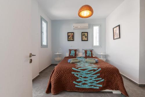 a bedroom with a bed with a brown blanket at Blue Diamond Beach Villas in Paphos City