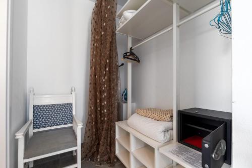 a room with a curtain and a laptop on a shelf at Blue Diamond Beach Villas in Paphos City
