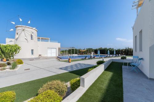 a view of a building with a water tower at Blue Diamond Beach Villas in Paphos City