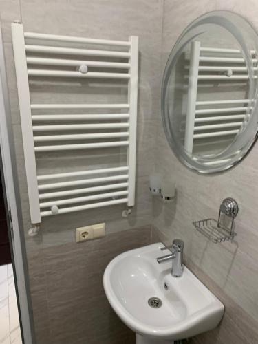 a bathroom with a sink and a mirror at KARD HOUSE in K'obulet'i