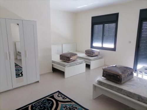 a room with three benches with bags on them at Durrat Al Israa in Umm el ‘Amad