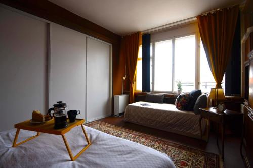 a hotel room with a bed and a window at Waterfront River Side Roof Top Apartment - Terrace with city view in Prague